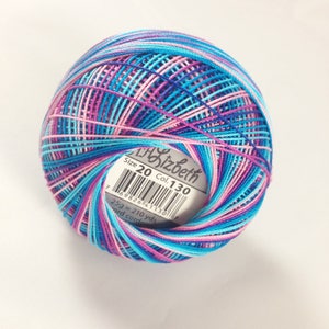May include: A ball of multi-coloured thread, predominantly blue, pink, and purple. The label reads "Lizbeth", size 20, and colour 130. The label also states the thread is 25g and 192 metres.