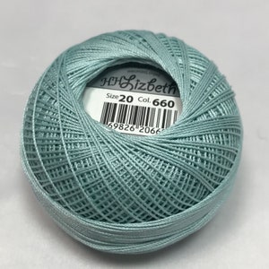 Puede incluir: Una madeja de hilo de bordar de algodón mercerizado azul claro, tamaño 20, color 660, con una etiqueta blanca que dice "Lizbeth" y tiene un código de barras.