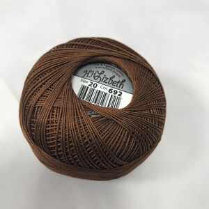 May include: A brown ball of 100% Egyptian cotton mercerized thread, labelled "HH Lizbeth" with "Size 20 Col. 692".