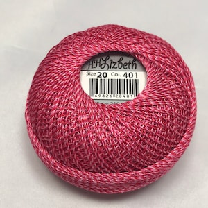 May include: A ball of red and white embroidery floss with a label that reads "DMC Lizbeth Size 20 Col. 401" and a barcode.