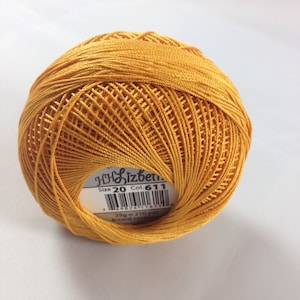 May include: A ball of yellow embroidery floss with a label that reads "Size 20 Col. 611", "25g = 210 yds", and "6-cord cotton".
