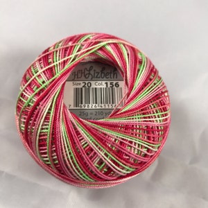 May include: A ball of multi-coloured embroidery floss in shades of pink, green, and white. The label reads "DMC Elizabeth Size 20 Col. 156 25g = 210 yd."