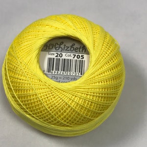 May include: A ball of Lizbeth Size 20 crochet thread in yellow, labelled with the colour number 705. The label also shows the weight of the ball, 25g, and the length of the thread, 210 yards.