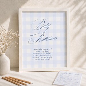 May include: A white framed sign with a light blue and white gingham pattern background. The text reads Baby Predictions and Please take a card and make your best predictions for baby's arrival, from the birth date and time to weight, length, and more!