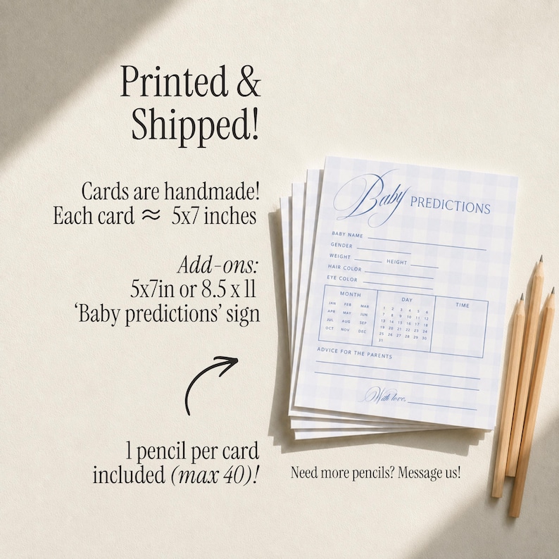 May include: A stack of light blue and white gingham patterned baby prediction cards with text fields for name, gender, weight, height, hair and eye color, and a calendar section. Three wooden pencils are placed next to the cards on the surface.