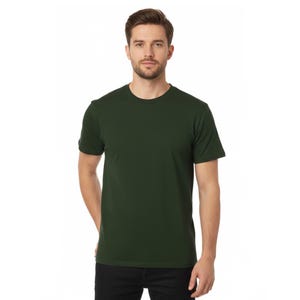 May include: A solid forest green crew neck t-shirt. The short-sleeved shirt is made of a soft material. The model is wearing black jeans. The shirt is a basic wardrobe staple.
