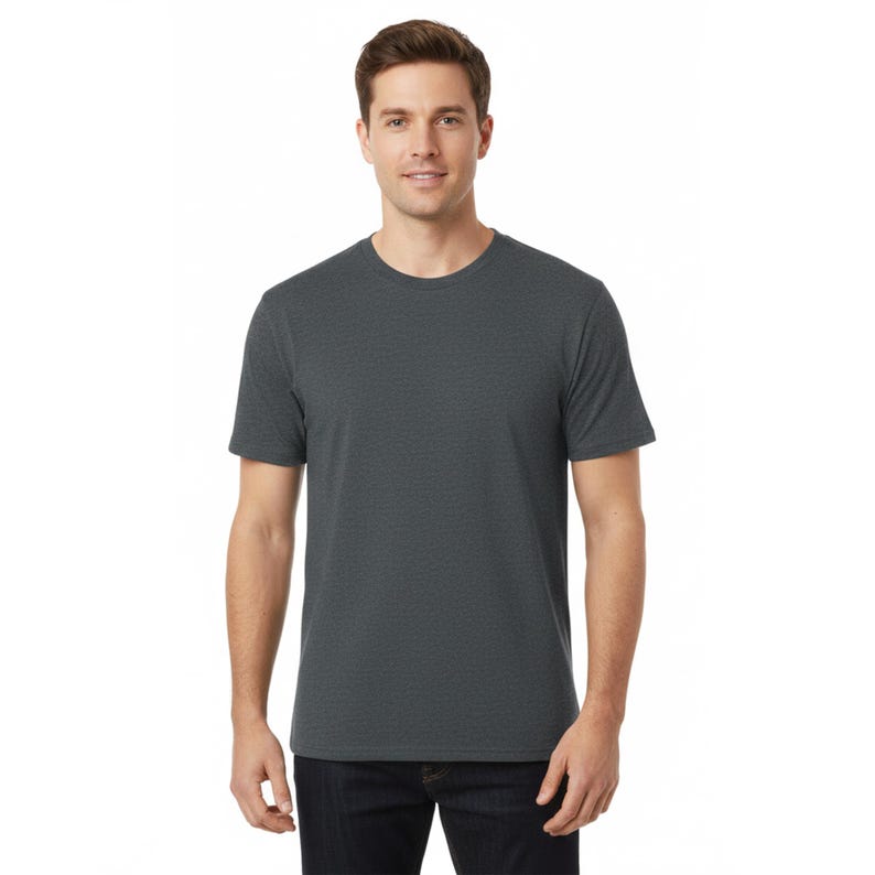 May include: A dark gray crew neck t-shirt. The short-sleeved shirt is made of a soft, textured fabric. The model is wearing the shirt with dark blue jeans.