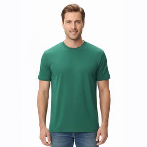 May include: A solid green crew neck t-shirt. The short-sleeved shirt is made of a soft material and is worn by a person. The person is wearing blue jeans. The background is white.