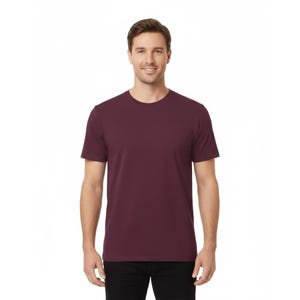 May include: A maroon crew neck t-shirt. The short-sleeved shirt is made of a soft material and is worn by a person. The shirt has a classic, simple design, suitable for casual wear. The background is white.