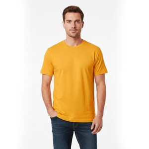 May include: A mustard yellow crew neck t-shirt. The short-sleeved shirt is made of a soft material. The person in the image is wearing blue jeans. The background is white.