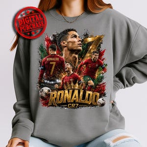 Gray sweatshirt mockup featuring a bold Ronaldo CR7 football graphic with multiple player poses, large gold number 7, crown detail, soccer balls, red and green paint splashes, black smoky textures, gold spark effects, and oversized metallic “RONALDO” lettering. Includes a red Digital Purchase stamp for a printable sports PNG digital download.
