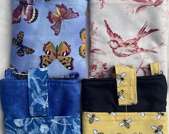 May include: Four rectangular fabric crossbody pouches with adjustable straps. One features blue butterflies, one has a red bird and floral print, one displays blue dragonfly patterns, and one shows yellow bees on a black and yellow background.
