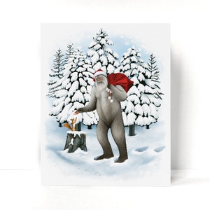 Santasquatch delivers a Christmas walnut to a small red squirrel. The squirrel stands on a snow covered stump and reaches for the gift. The background is a snowy landscape in pale blue and white, with dark snow covered evergreens. No text.