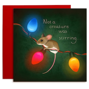 This is a square card. A brown mouse sits on the wire of a set of Christmas lights. The lightbulbs are orange, red, and blue. They shine against a dark green background. There is an indication of pine branches in the background.