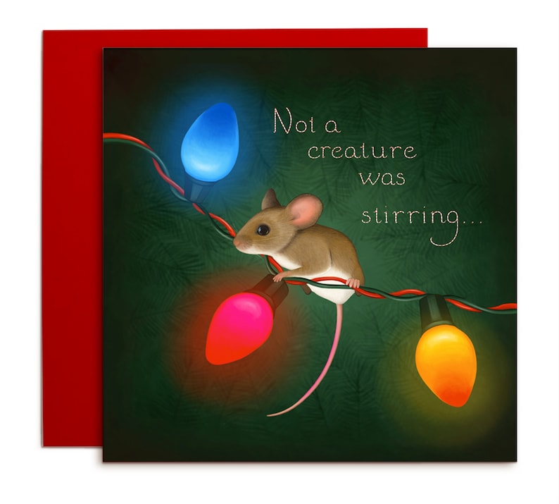 This is a square card. A brown mouse sits on the wire of a set of Christmas lights. The lightbulbs are orange, red, and blue. They shine against a dark green background. There is an indication of pine branches in the background.
