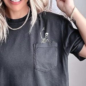 Waving Skeleton Pocket Tee, Halloween shirts for women, cute Halloween shirt, skeleton in pocket tee, Funny Skeleton Halloween Tee