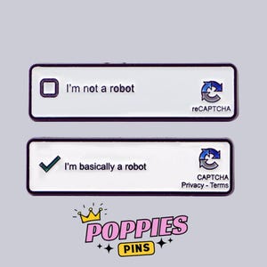 May include: Two rectangular enamel pins with black borders. The top pin reads "I'm not a robot" with a checkbox. The bottom pin says "I'm basically a robot" with a checkmark. Both pins have a reCAPTCHA logo. The "POPPIES PINS" logo is at the bottom.