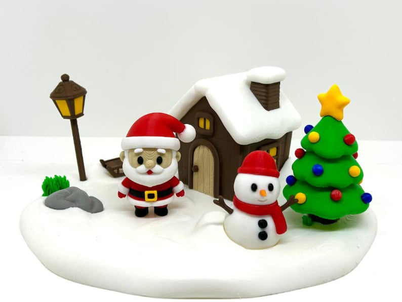 May include: A miniature Christmas scene featuring a Santa Claus figure, a snowman with a red scarf, a brown house with a white snow-covered roof, a green Christmas tree with colourful ornaments and a yellow star, and a brown street lamp.