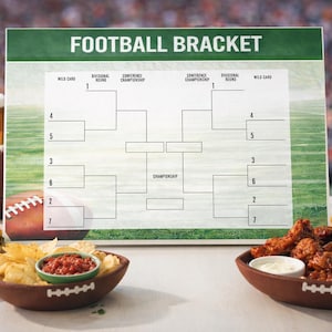 May include: A football bracket board with a green and white design, surrounded by game day snacks like chips, salsa, chicken wings, and burgers. Two glasses of beer and footballs are also present, creating a festive atmosphere.