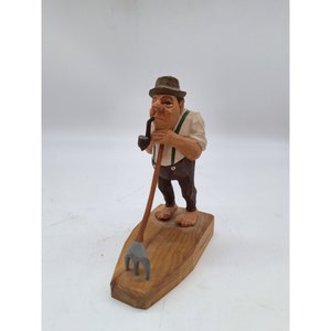Vintage Black Forest folk art wood carving figurine barefoot man farm rake pipe