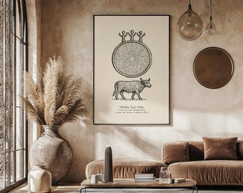 May include: A framed print featuring a black and white illustration of a sun disk and a bull. The text "Hittite Sun Disk" is below the bull. The print hangs above a brown sofa in a room with a large window and decorative vase.