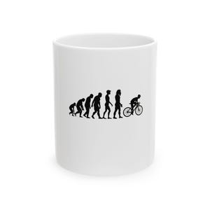 May include: White ceramic mug featuring a black silhouette design depicting the evolution of man, culminating in a cyclist on a bicycle. The mug has a cylindrical shape and a simple, clean design.