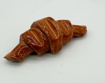 Handmade ceramic croissant brush rest.