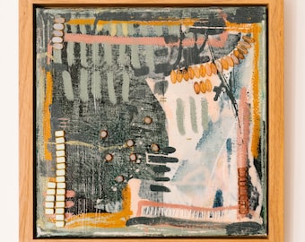 May include: A square mixed media canvas painting in a light wood frame featuring abstract layers of dark charcoal, sage green, and soft pink paint. The composition includes applied rows of small white and brown beads and scattered circular accents.