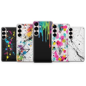 May include: Five phone cases with colorful abstract designs. The cases feature a variety of patterns, including paint splatters and dripping paint effects in vibrant colors like pink, yellow, and blue. The cases are black, white, and clear.