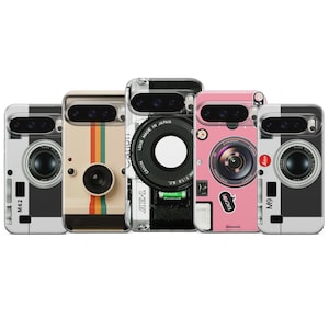 May include: Five phone cases with camera designs. The cases feature various designs, including a black and white camera, a beige case with colorful stripes, and a pink case with a sticker. Each case has a camera lens design.