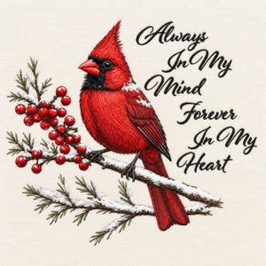 May include: An embroidered design featuring a bright red cardinal bird perched on a snowy branch with red berries. The text reads Always In My Mind Forever In My Heart in a black cursive script against a light cream-coloured fabric background.