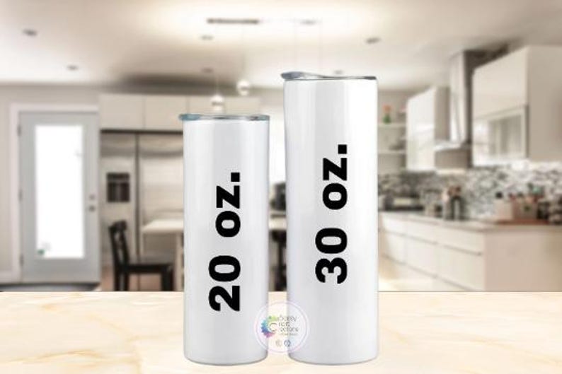 Puede incluir: Dos vasos aislados blancos con texto negro que indica tama&ntilde;os de 591 ml y 887 ml. Los vasos tienen tapas plateadas y son de forma cil&iacute;ndrica. El fondo es una cocina borrosa.