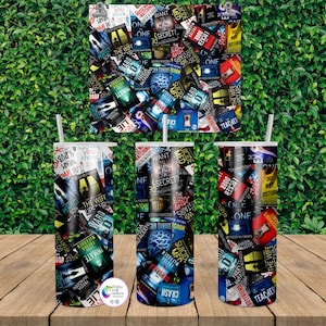 May include: Three 590 ml stainless steel tumblers and a matching print, all featuring a collage of book covers with titles like "The Wife Upstairs" and "One Secret". The design includes various colours and text.