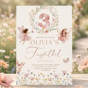 May include: A fairy-themed birthday invitation with a floral wreath and the number 3. The invitation features two fairy illustrations, butterflies, and floral accents. The text reads "Olivia's Fairy Third Birthday". The invitation is in soft pastel colors.
