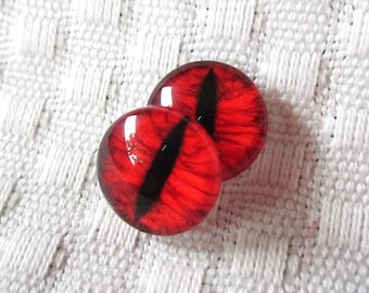 May include: Two red glass eyes with black pupils, suitable for craft projects.