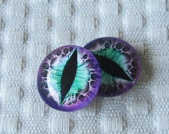 May include: Two purple and green glass eyes with black pupils. The eyes have a white background with a swirling pattern.