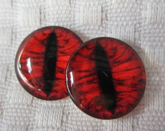 May include: Two red and black glass eyes with a black pupil and a red iris. The eyes are round and have a glossy finish.