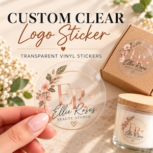 May include: A round transparent vinyl sticker featuring a rose gold logo with the letters ER, the text Ellie Roses Beauty Studio, and a floral design. The sticker is held up, with another sticker on a cardboard box and a glass candle jar.