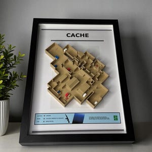 Puede incluir: Mapa 3D enmarcado de un nivel de videojuego, con la etiqueta "CACHE". El mapa es de color beige con marcadores rojos y azules. El marco es negro y el fondo blanco. La parte inferior del marco tiene texto y un gráfico azul y verde.