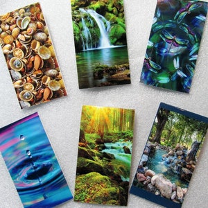 May include: A collection of rectangular decorative tiles featuring various nature-themed images. The tiles showcase a seashell arrangement, a waterfall, dragonflies, water droplets, a forest scene, and a tranquil stream with rocks.