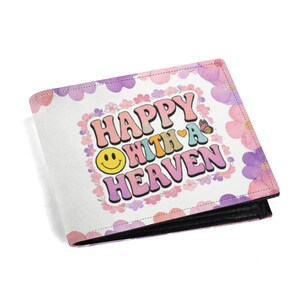 May include: A bi-fold wallet with a white background and a floral design. The front features the words "HAPPY OHITH A HEAVEN" in a retro font, with a smiley face and butterfly. The wallet has a black interior.