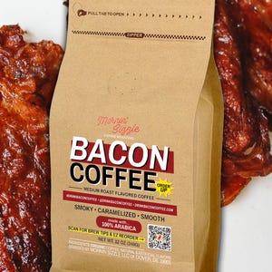 May include: A brown paper coffee bag labeled Mornin' Sizzle Bacon Coffee with a medium roast description, 12 oz (340g) net weight, a QR code, and text including smoky, caramelized, smooth, and 100% Arabica, set against a background of cooked bacon strips.