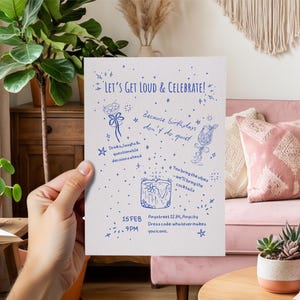 May include: A white rectangular invitation card featuring blue hand-drawn illustrations and text that reads: Let's Get Loud & Celebrate! Because birthdays don't do quiet. Drinks, laughs & questionable decisions ahead. You bring the vibes - we'll bring the cocktails. 15 FEB 9PM. Anyastreet 1234, Anycity. Dress code: whatever makes you iconic.
