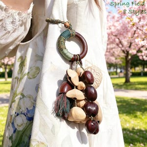 May include: A decorative wooden ring with a wrapped green and brown section, attached to a collection of natural-toned wooden beads and dark brown seed pods. The image includes the text "Spring Field 8 Styles".