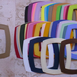 May include: A set of 20 different colored oval-shaped frames with stitched edges. The frames are arranged in a staggered pattern, with the largest frame at the bottom and the smallest frame at the top.