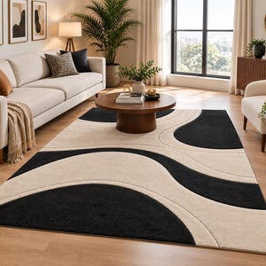 May include: A rectangular area rug featuring a high-contrast design of large, sweeping black and cream-colored curved shapes. The rug has a thick, plush pile texture and covers a significant portion of the floor, creating a bold visual pattern.
