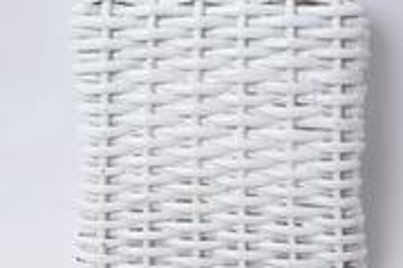 May include: Close-up of a white woven wicker texture. The weave pattern is tightly knit, creating a solid, opaque surface. The white color is bright and consistent, suggesting a clean, modern aesthetic. The texture is likely from a piece of furniture or a decorative item.