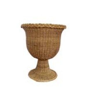 May include: A woven wicker planter with a pedestal base. The planter has a wide, fluted top and a textured, basket-weave design. The natural brown color of the wicker adds a rustic touch. The planter stands approximately 24 inches tall.
