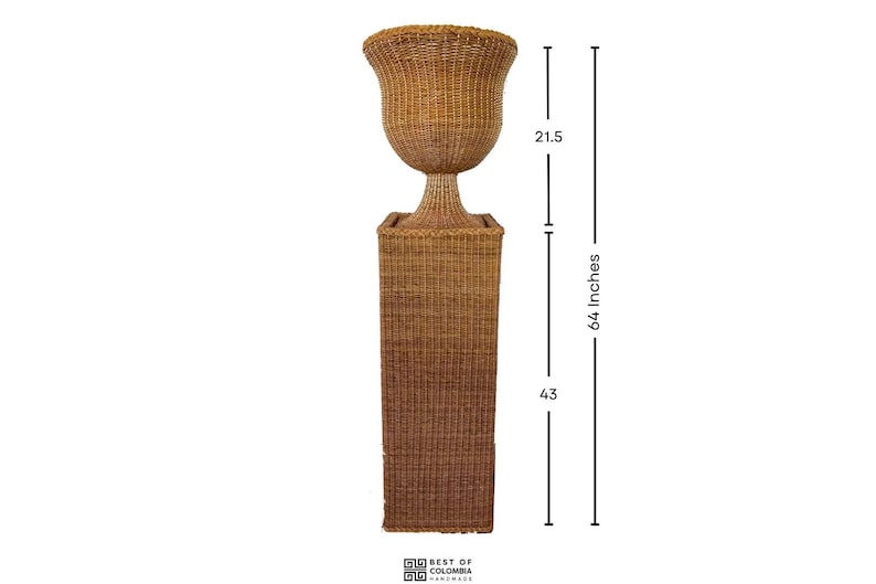 May include: A tall, woven wicker planter with a flared top, measuring 64 inches in height. The planter has a square base and a bulbous upper section, connected by a slender pedestal. The overall color is a warm, natural brown.