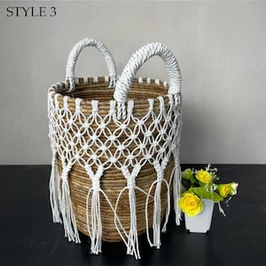May include: Woven basket with white macrame detailing and handles. The basket has a natural brown color with a white macrame overlay and fringe. The text "STYLE 3" is in the upper left corner.